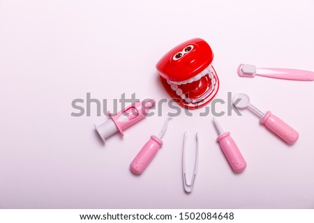 Teeth brush and jaw copy space. Prevention and care children's teeth on white wooden background. Top view. Child dentist concept toy.