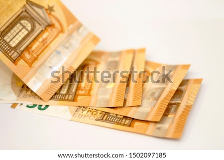 Stack of Fifty euro banknotes laying isolated on white background