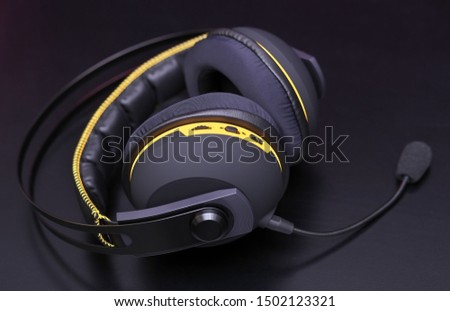Professional headphones with a microphone for gamers on a black background