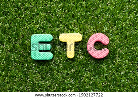 Toy foam letter in word etc (abbreviation of et cetera) on green grass background Royalty-Free Stock Photo #1502127722