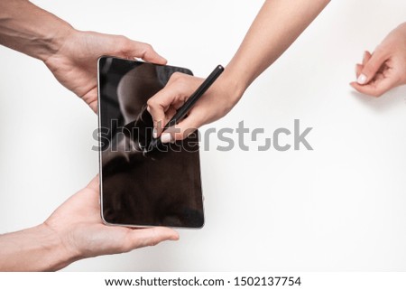 Close up top view of a male signing contract on a tablet. Concept of busines strategy building using modern technoloies.