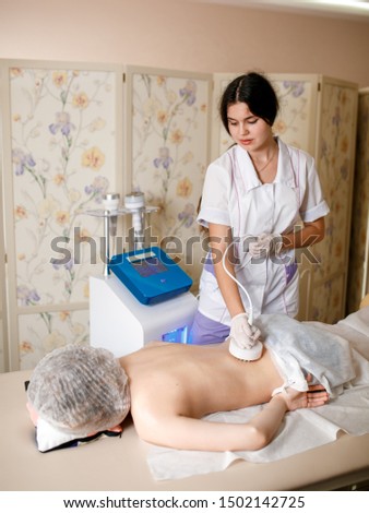 Hardware cosmetology. Picture of happy young woman with closed eyes getting rf lifting procedure in a beauty parlour