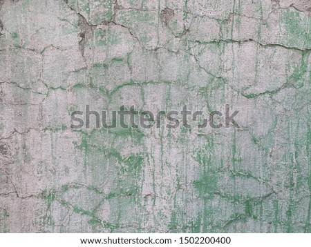 Old cracked painted wall with green drips texture. Old painted cracked wall close up with copy space background