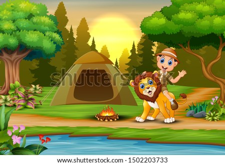 Zookeeper boy and a lion in campsite at sunset landscape