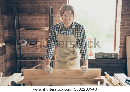 Portrait of his he nice attractive handsome blond cheerful cheery guy builder creating new project start-up shop at industrial brick loft style interior workplace