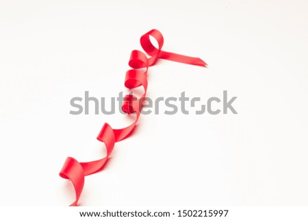 Red ribbon to make ties in Christmas gifts. Ribbon and bows to decorate anniversary gifts, various gifts.
