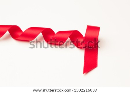 Red ribbon to make ties in Christmas gifts. Ribbon and bows to decorate anniversary gifts, various gifts.
