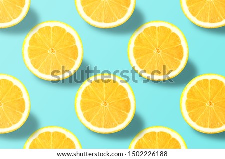 Fruit pattern. Colorful of fresh lemon texture slices on blue background. From top view. Photography collage. Minimal summer fruits pattern for blog or recipe book.