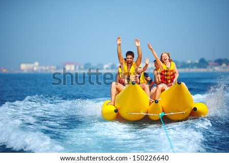 happy people having fun on banana boat Royalty-Free Stock Photo #150226640