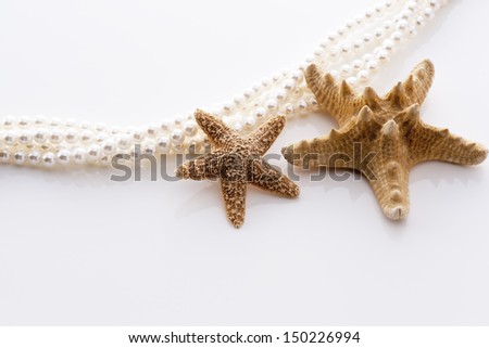 a background image of starfish and pearl on white sands