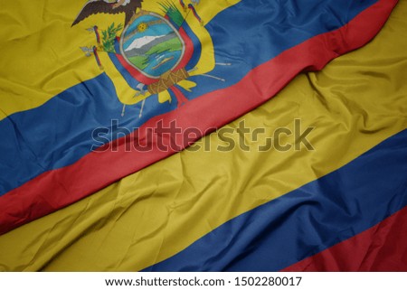 waving colorful flag of colombia and national flag of ecuador. macro