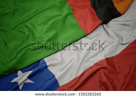 waving colorful flag of chile and national flag of zambia. macro