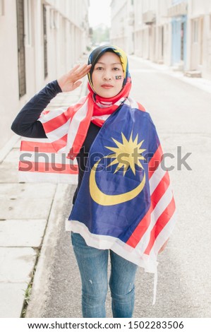 Portrait of Face painted with malaysian flag