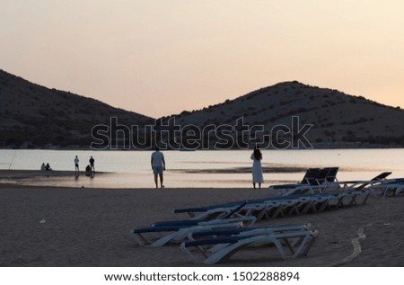 People on the seashore watching the sunset