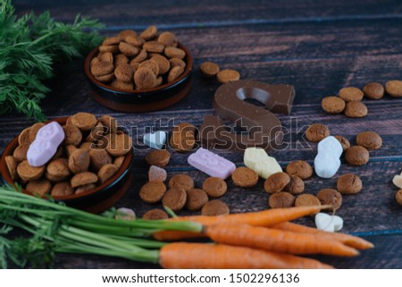 Dutch holiday Sinterklaas. Background with traditional food - pepernoten, chocolate letter, sweets strooigoed and carrots for horse. Concept for children party in Saint Nicolas day five december.
