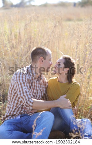 Young adult happy family couple rest outdoor, looking at camera