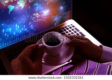 Photo professional investor working on  laptop computer, and looking sheet analysis charts and graph finance  and  holding white cup of coffee.