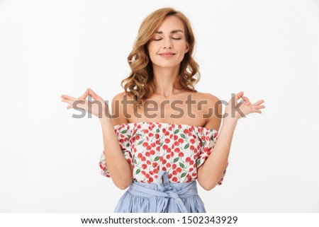 Photo of a cute pleased woman posing isolated over white wall background meditate keep calm.