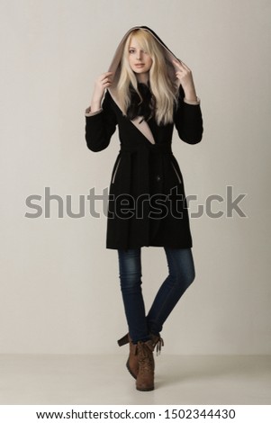 slim blonde girl in jeans and coat