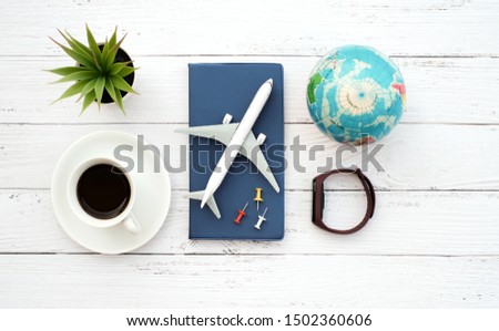 Flat lay planing and traveler concept on white wooden table background with passport and plane, Top view with copy space