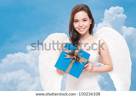 Portrait of a cute angel holding a wrapped gift