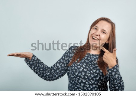 brunette girl in dark blouse over isolated white background shows emotions
