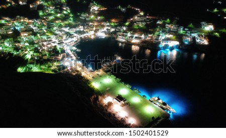 Aerial drone night shot of small illuminated picturesque port of Yalos in main town of Astypalaia island, Dodecanese, Greece
