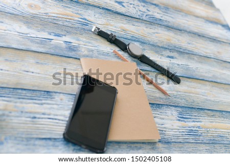 Picture of Wrist Watch with Stationary and Telephone on Wood Floors Holiday concept