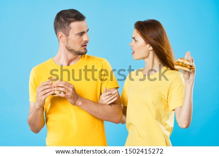 Man and woman with hamburger in hands diet food lifestyle snack