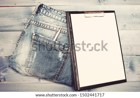 Medical insurance. Paper tablet and pen on jeans background copy space. History of the disease. Medical treatment. Medical help and consultation. Interviewing patient. Psychoanalysis concept.