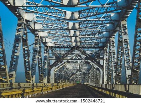 Metal bridge  over asphalt road, national highway, Assam