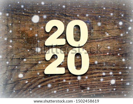 2020. Dark wood texture 2020.New year background. Retro wooden table. Rustic background. White snowflakes , snow, bokeh. Copy space.Christmas background, New year.Dark wood texture.