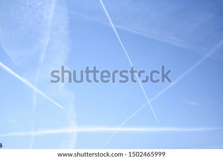 Blue sunny sky with plane trails