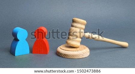 Two figures of people opponents stand near the judge's gavel. The judicial system. Conflict resolution in court, claimant and respondent. Court case, resolution and disputes settling disputes. Royalty-Free Stock Photo #1502473886