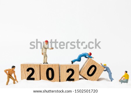 Miniature people : Worker team create wooden block number 2020  , Happy new year concept