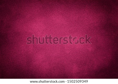 Dark purple matte background of suede fabric, closeup. Velvet texture of seamless wine leather. Felt material macro with vignette. Royalty-Free Stock Photo #1502509349