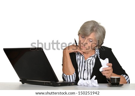 older woman with a laptop on a white background