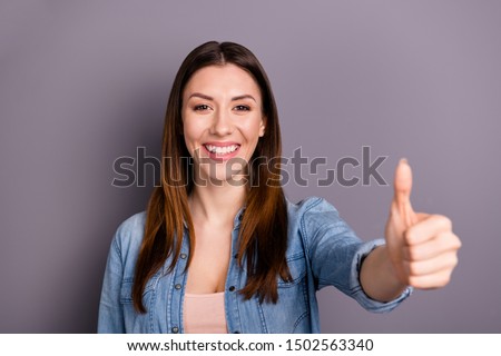 Portrait of positive cheerful lady show her thumb up demonstrate feedback sales discounts wear denim jeans good look outfit isolated over grey color background