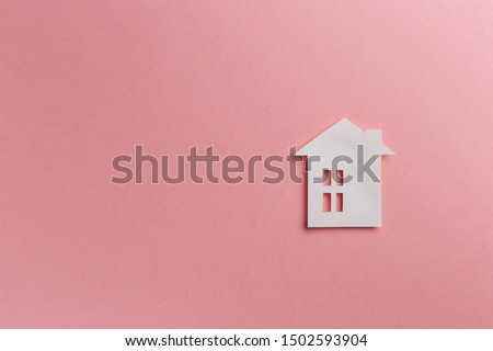 Minimalistic paper house on a pink background. Top view. Flat lay. Copy space. Colorful background. New minimal creative concept