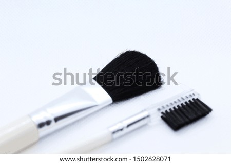 Small makeup brushes on a white background