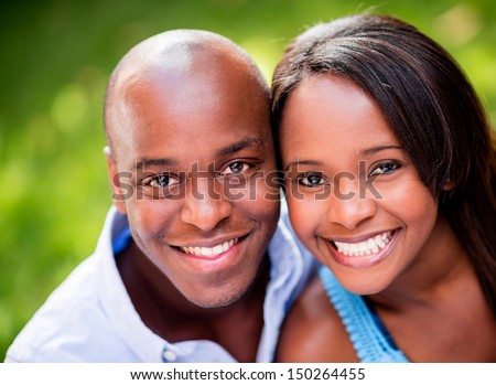Portrait of a beautiful couple smiing outdoors  Royalty-Free Stock Photo #150264455