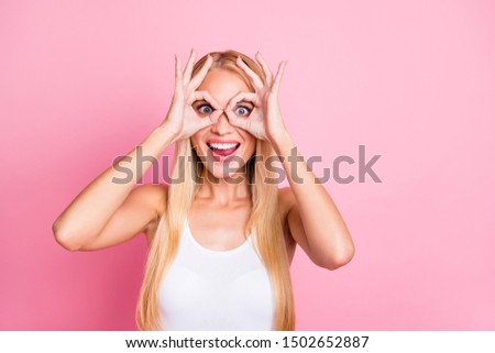 Photo of pretty lady showing okey symbol near eyes making specs shape observe sale prices wear casual outfit isolated on pink color background