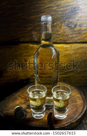 Aguardiente or aguardente Traditional Spanish and Brazilian alcoholic drink, strong drink, grape brandy, rum, gin, silver tequila, pinga, Brazilian cachaça, Russian vodka, in glasses on an old rustic. Royalty-Free Stock Photo #1502657615