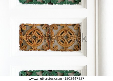 White ancient wall decorate with china square style tile