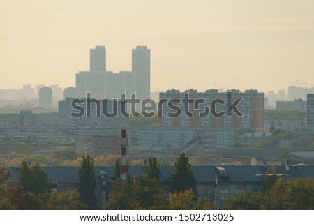 Photography of the suburb sleeping area of Moscow in the sunset. View from above / top view. Chimneys of Heat station. Lifestyle of big city in summer time.
