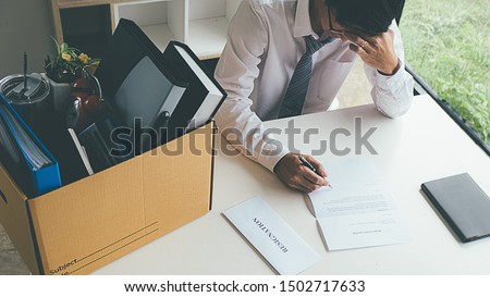 Sad dismissed businessman sitting outside the office after losing his job Royalty-Free Stock Photo #1502717633