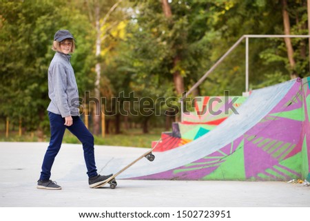 Skater girl on skatepark moving on skateboard outdoors.