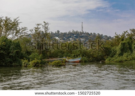 Beautiful View of Ilemela hill from Lake side . Focus on small boat . I shoot this picture in Mwanza Tanzania.