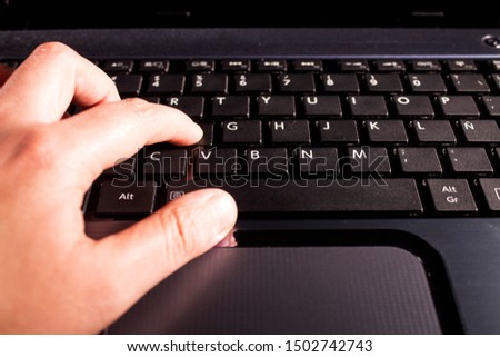 Typing on a gray laptop keyboard