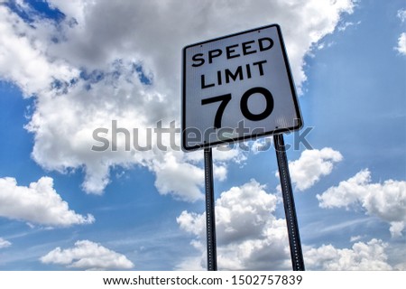 Speed limit 70 sign with clouds Royalty-Free Stock Photo #1502757839